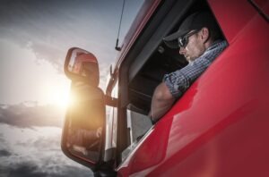 A Sioux Falls truck driver in a red cab hits the road on I-29