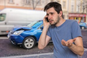 A man makes a call after a car accident in South Dakota. Learn what to do after a car accident and how a personal injury lawyer can help you recover damages.